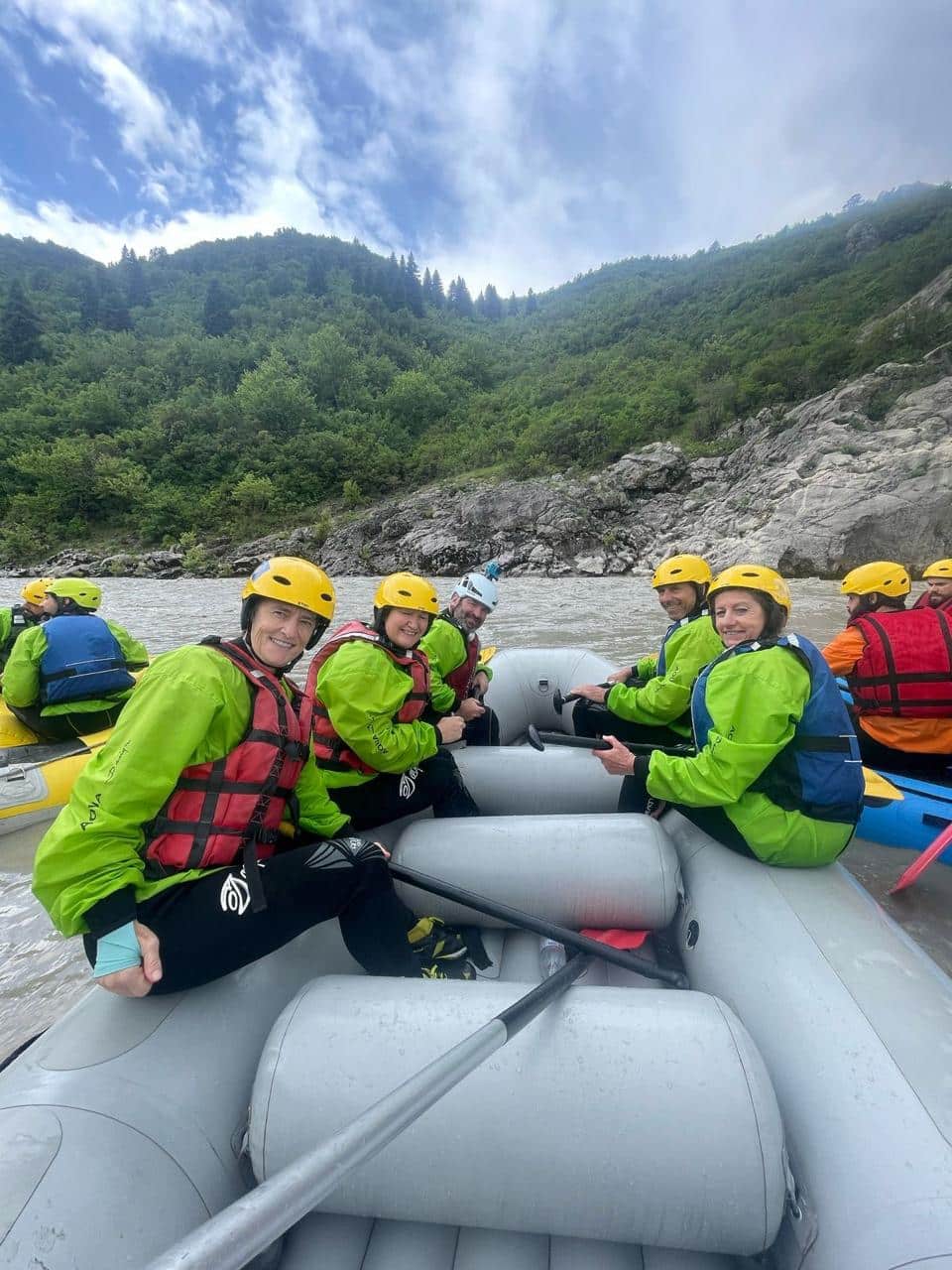 A group of smiling people in a raft on the Vjosa River.